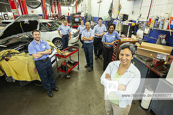 Portrait of a team of Mechanics in Auto Repair Shop viewed from above