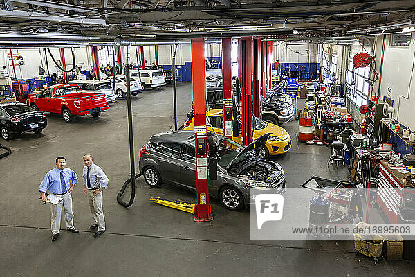 Portrait of two managers in auto repair shop viewed from above