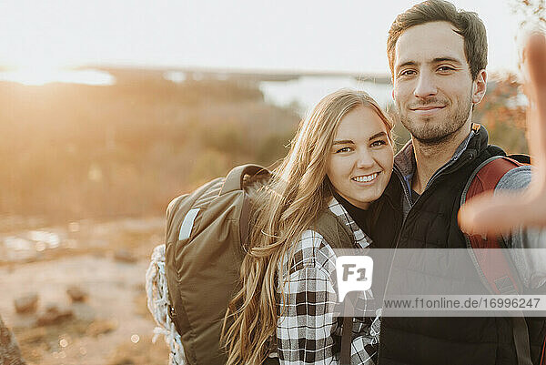 Portrait of young couple posing together during autumn hike