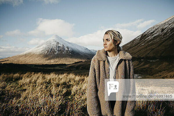 UK  Scotland  Loch Lomond and the Trossachs National Park  pensive young woman standing in rural landscape