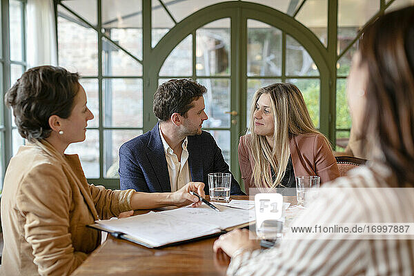 Couple in meeting with female event planner in her studio