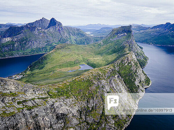 Scenic view of mountain range by sea at Segla  Norway