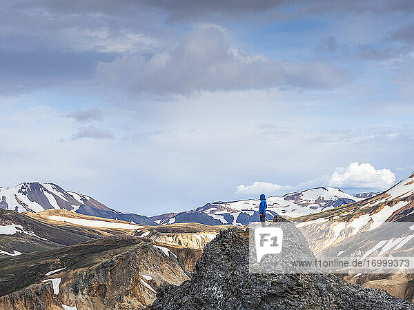 Hiker standing on top of volcanic hill in Landmannalaugar