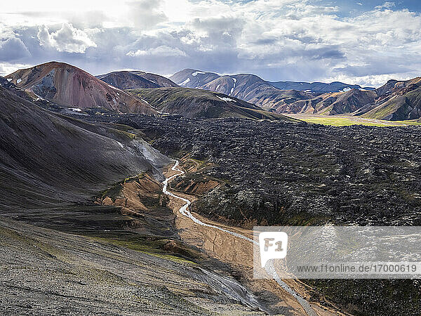 Scenic view of stream flowing across volcanic valley in Landmannalaugar
