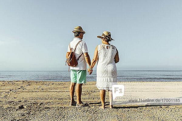 Rear view of senior couple on the beach  El Roc de Sant Gaieta  Spain