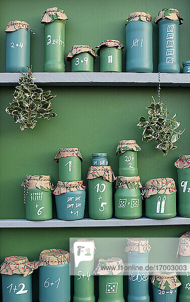 DIY green painted jars representing Advent Calendar
