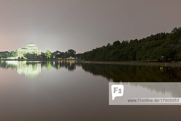 USA  Washington DC  Jefferson Memorial and surrounding trees reflecting in Tidal Basin at night