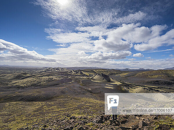 Man looking at landscape while standing on rock during sunny day  Lakagigar  Iceland
