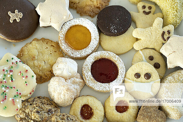 Various ready-to-eat Christmas cookies  one wearing protective face mask
