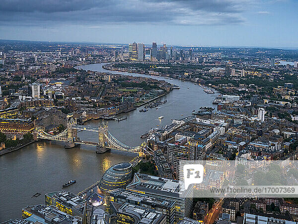 UK  England  London  Helicopter view of River Thames  Tower Bridge and surrounding buildings at dusk