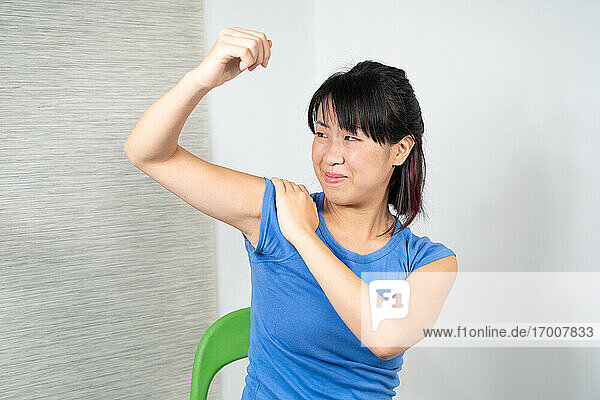 Asian woman having shoulder pain