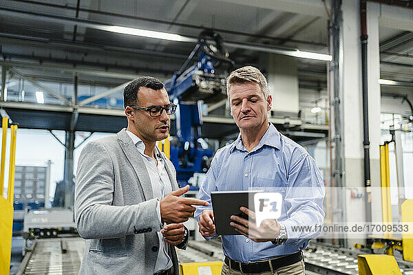 Mature manager and supervisor working on digital tablet in industry