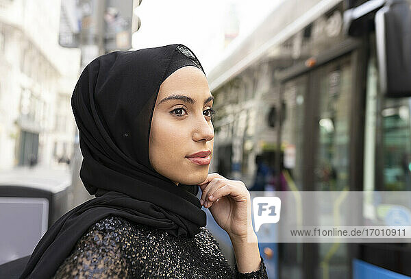 Portrait of young beautiful woman wearing black hijab