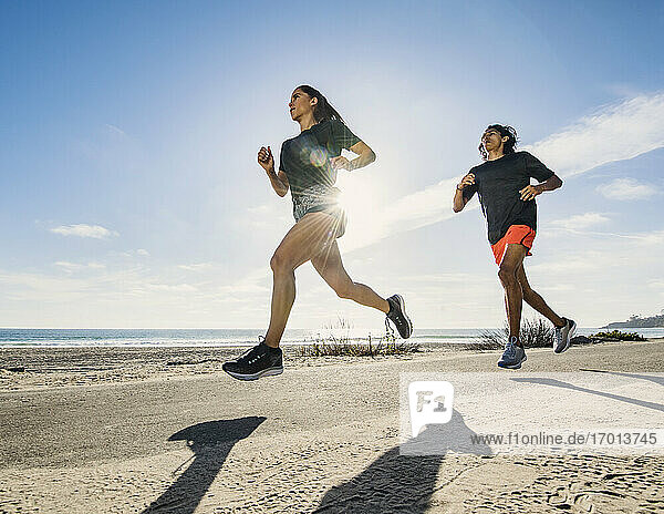 USA  California  Dana Point  Man and woman running together by coastline