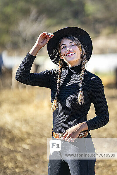 Portrait of female rancher in black hat