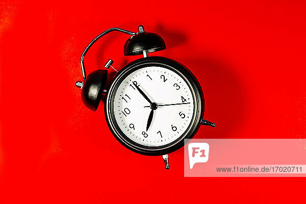 Alarm clock against red background