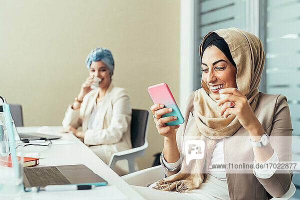 Businesswoman in office  using phone