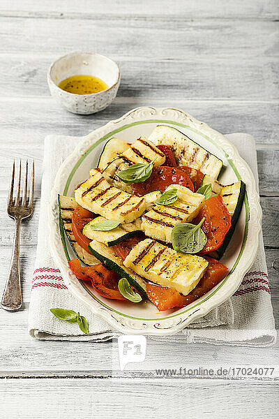 Grilled halloumi salad with zucchini  peppers  tomatoes and basil