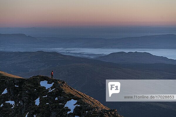 Hiking Ben Lomond 974m summit at sunset in the mountains of Loch Lomond and the Trossachs National Park  Scottish Highlands  Scotland