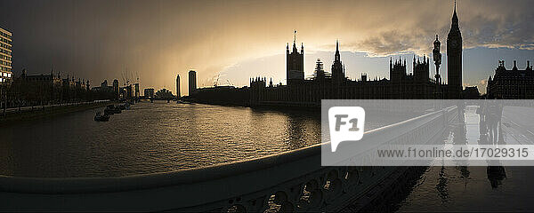 Houses of Parliament (Palace of Westminster) and Bg Ben silhouetted at sunset  seen from Westminster Bridge  London  England