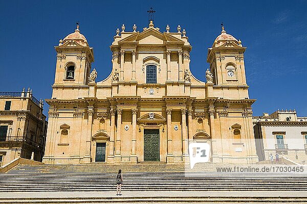 Noto  Sicily  a tourist visiting St Nicholas Cathedral (Noto Cathedral  Cattedrale di Noto)  a Baroque building in Noto  Sicily  Italy  Europe. This is a photo of a tourist visiting St Nicholas Cathedral (Noto Cathedral  Cattedrale di Noto)  a Baroque building in Noto  Sicily  Italy  Europe