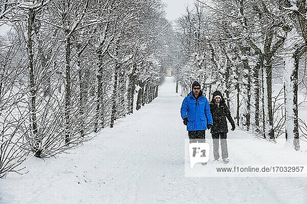 Stockholm  Sweden A couple walking on the grounds of the Drottningholm Royal Palace in the snow.
