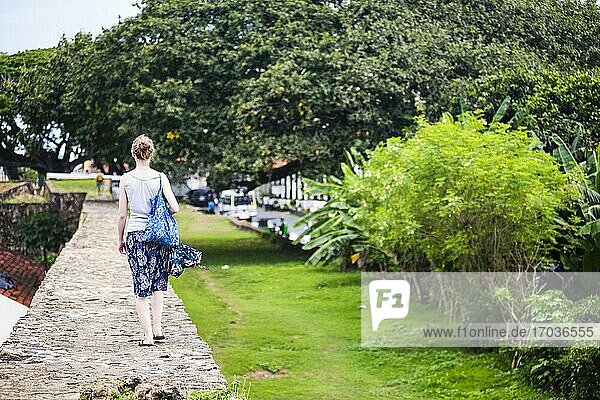 Tourist walking along the old city walls of the Old Town of Galle  a UNESCO World Heritage Site on the South Coast of Sri Lanka  Asia