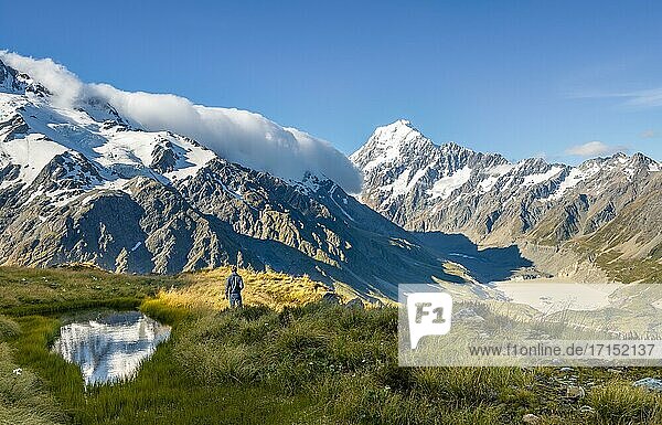 Hiker at a mountain lake  view of Hooker Valley with Hooker Lake and Mount Cook  Sealy Tarns  Hooker Valley  Mount Cook National Park  Southern Alps  Canterbury  South Island  New Zealand  Oceania