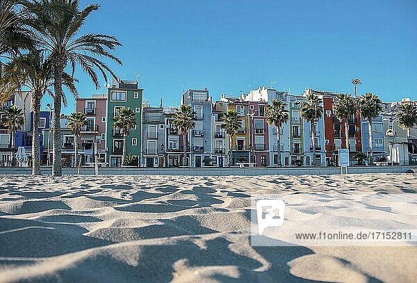 Farbige Häuser (Cases de Colors) am Sandstrand in Villajoyosa an der Costa Blanca mit Palmen in der Nähe von Benidorm.