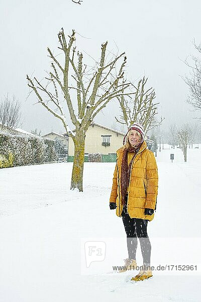 Caucasian young woman enjoying snow outdoor in winter time. Navarre  Spain  Europe.