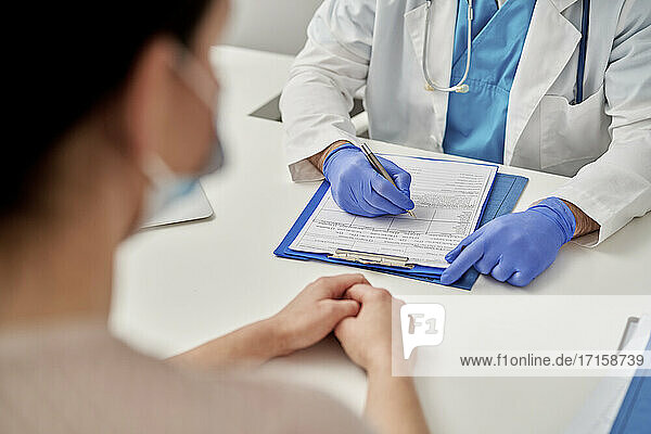 Medical professional prescribing new treatment to patient