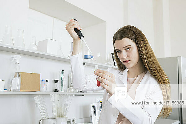Female scientist pipetting at laboratory