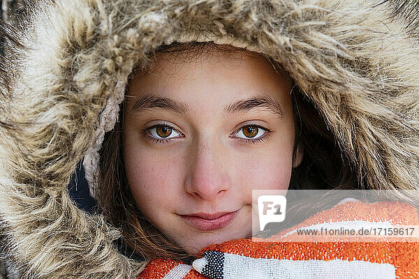 Close-up portrait of girl wearing fur coat