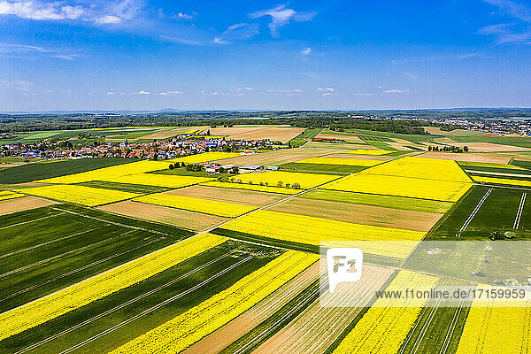 Germany  Hesse  Munzenberg  Helicopter view of countryside village and surrounding fields in summer