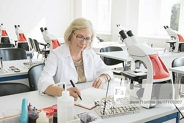 Portrait of senior female researcher in science class