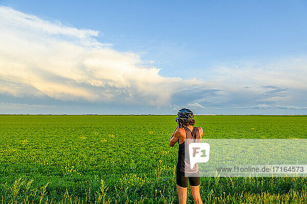 Man photographing green field  Ontario  Canada