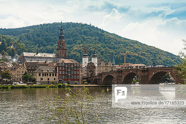 Germany  Baden-Wurttemberg  Heidelberg  Karl Theodor Bridge spanning over river Neckar with old town buildings in background