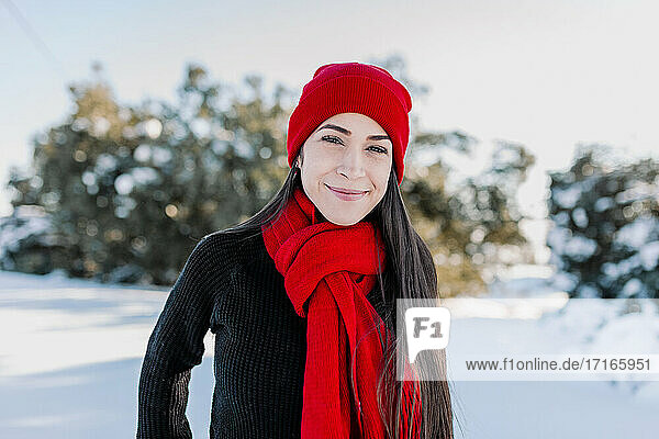 Smiling beautiful woman enjoying vacation at countryside during winter