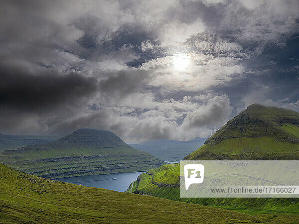 Idyllic view of mountains against cloudy sky  Funningsfjordur  Iceland