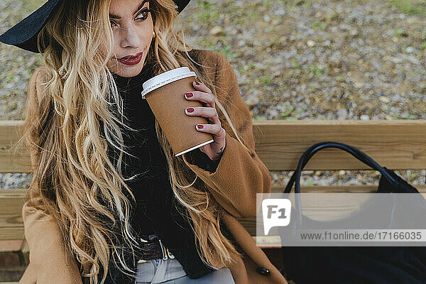 Woman drinking coffee while looking away