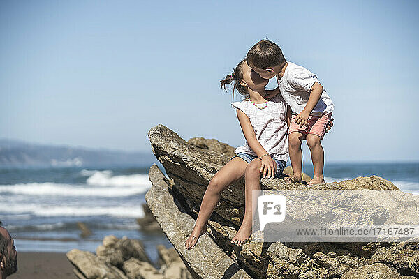 children enjoying the beach and cliffs of the Basque country