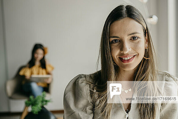 Beautiful woman in waiting area while daughter sitting in background