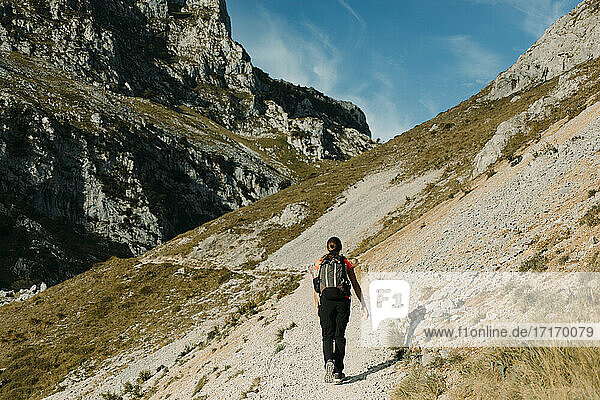 Woman with backpack hiking on Cares Trail at Picos De Europe National Park  Asturias  Spain