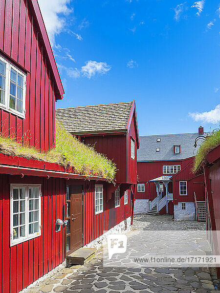 Alley amidst red houses against blue sky  Torshavn  Faroe Islands  Iceland