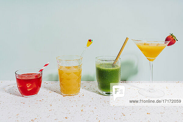 Healthy summer cocktails on terrazzo marble against wall at home