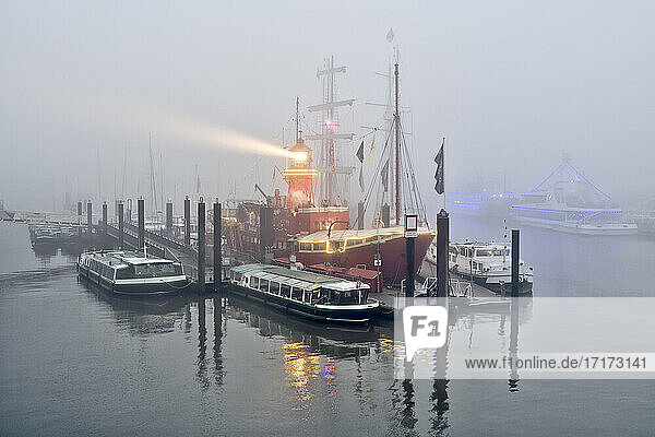 Germany  Hamburg  Lightship and various boats moored in foggy harbor