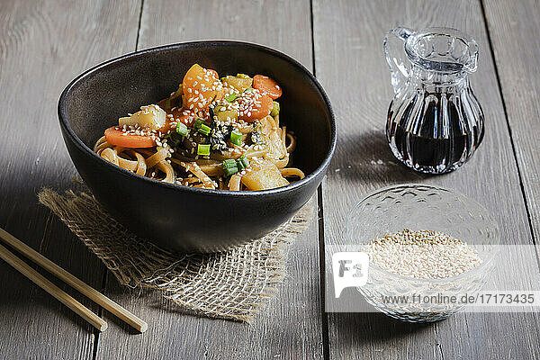 Bowl of vegan pasta with vegetables and sesame seeds