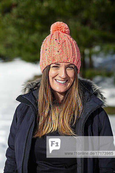 Smiling woman in warm clothing during winter
