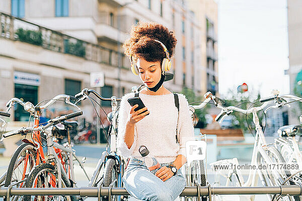 Young woman outdoors  looking at phone