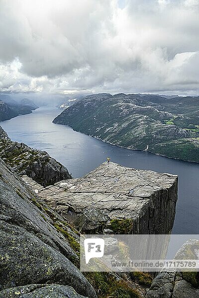 Single person on rock plateau  Preikestolen rock spire  Lysefjord  Ryfylke  Rogaland  Norway  Europe